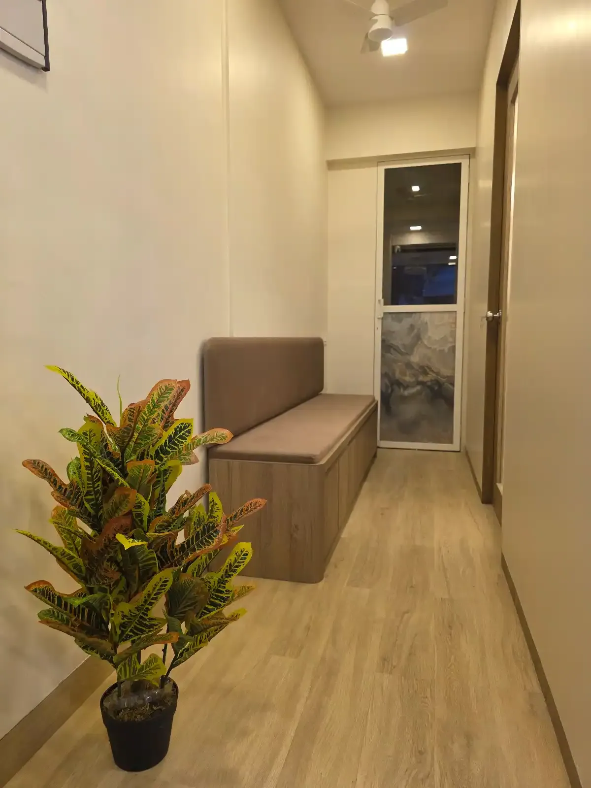 Patient waiting area at Aarogya Women’s Clinic with bench seating and a potted plant